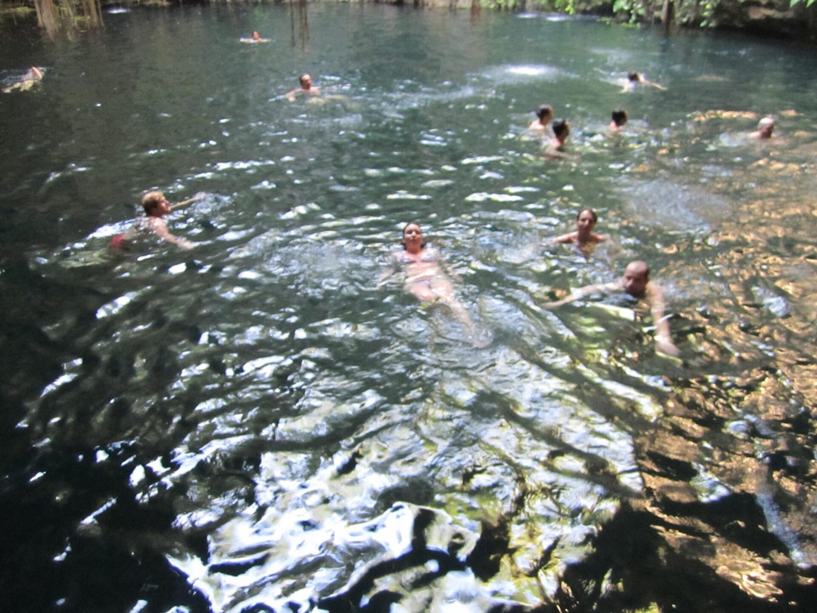 Swimmers in the turquoise water of a Yucatán cenote