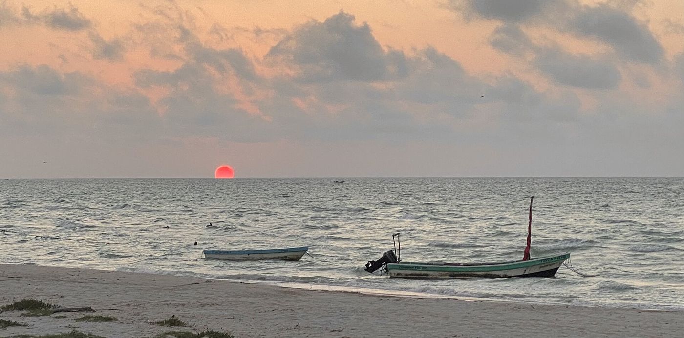 Sunset and a boat off the Progreso malecón