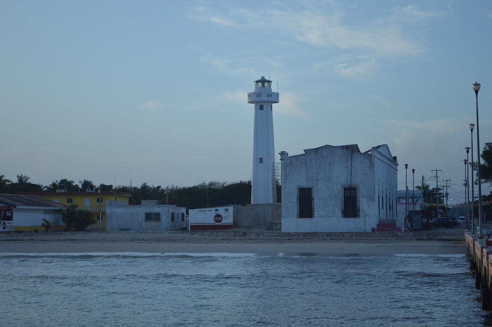 White lighthouse and the small museum building on the Telchac Puerto waterfront